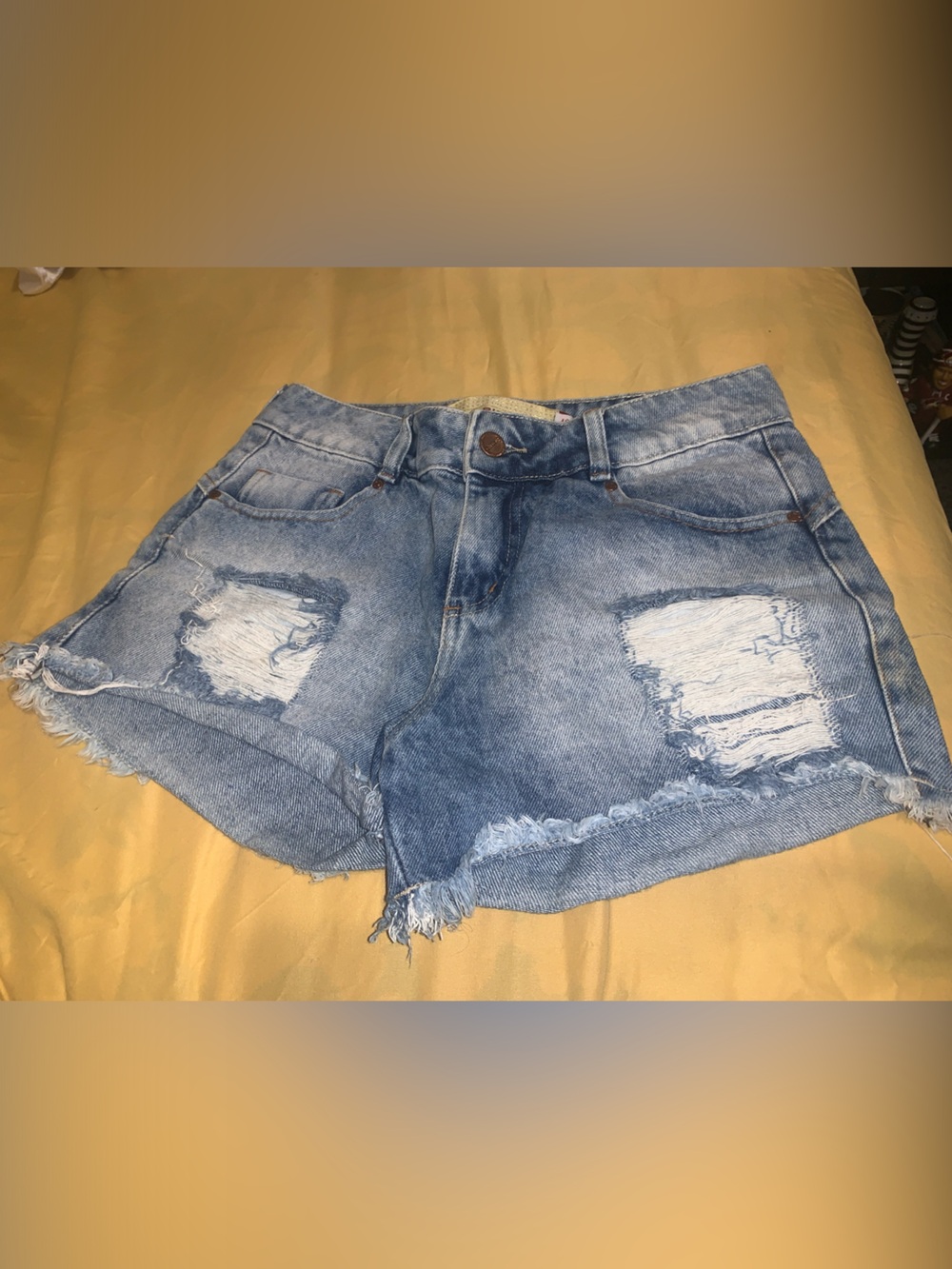 High-Rise Distressed Denim Shorts in Light Blue